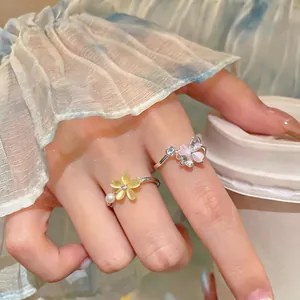 Detailed macro view of exquisite rotatable zircon flower and butterfly open rings