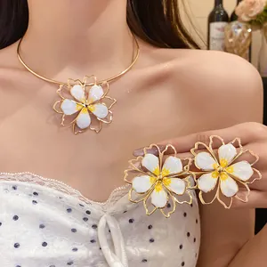 Detailed view of the elegant hollow flower neck ring and earrings set on a model