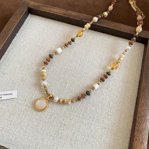 Close-up detail of Bohemian 18K gold-plated beaded necklace with stones and pearls
