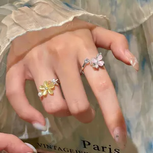 Detailed view of sweet zircon flower and butterfly rotating open rings for women
