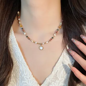 Close-up of a Bohemian 18K gold plated beaded stone necklace with a pearl pendant