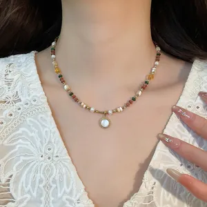 Detailed view of bohemian style 18K gold plated beaded necklace with pearls and stones