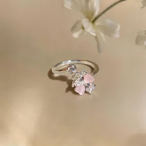 Close-up of a sweet zircon flower open ring featuring pink and clear petal-shaped stones