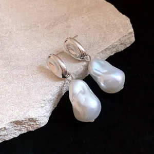 Close-up detail of French vintage pea-shaped pearl drop earrings with elegant silver finish.