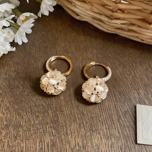 Close-up of elegant 18k gold plated flower ball earrings with sparkling cubic zirconia