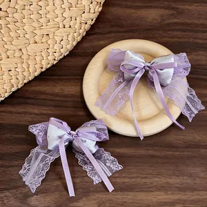Elegant purple lace bow hair clips with satin finish and rhinestone details