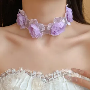 Close-up detail of a purple floral lace choker with three 3D flowers