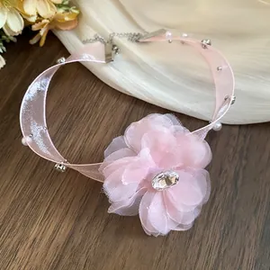 Close-up detail of a pink organza flower choker with sparkling rhinestones and pearls