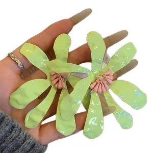 Exaggerated lime green flower earrings with pink stamen for summer vacation style