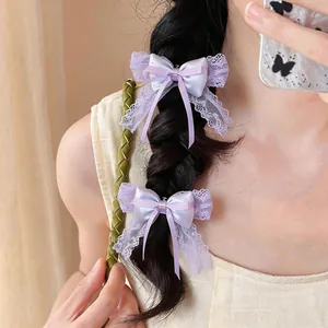 Close-up of elegant purple lace satin bow hair clips on a dark braided hairstyle
