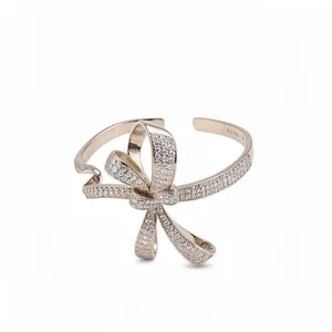 Elegant silver-toned bow cuff bangle featuring sparkling cubic zirconia paving for women.