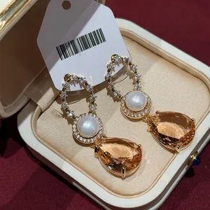 Retro 18k gold plated earrings featuring white pearls and amber-toned pear-cut stones.