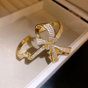 Detailed view of gold bow bracelet pavé-set with sparkling cubic zirconia stones