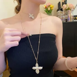 Elegant gold double-layered rhinestone flower butterfly pendant necklace for women.