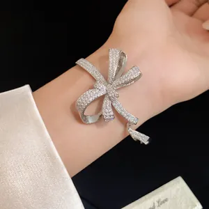 Detailed view of silver-toned bow bracelet pavé-set with sparkling cubic zirconia