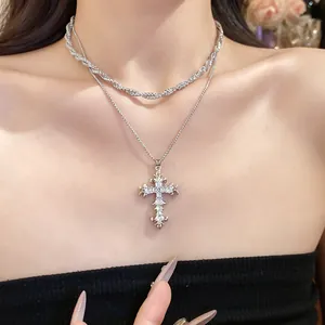 Detail view of silver gothic cross pendant necklace with sparkling zircon stones