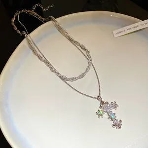 Close-up macro view of a sparkling zircon double-layered cross pendant necklace