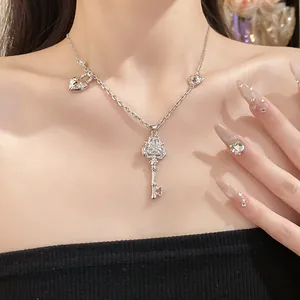 Detailed shot of vintage silver key pendant necklace with zircon stones on model