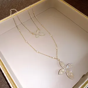 Detail view of double-layer necklace featuring two sparkling rhinestone flower pendants.