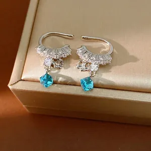 Elegant silver zircon iris flower ear clips with sparkling blue crystal pendant drops
