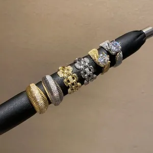 Elegant collection of 14k gold plated zircon rings displayed on a black jewelry rod