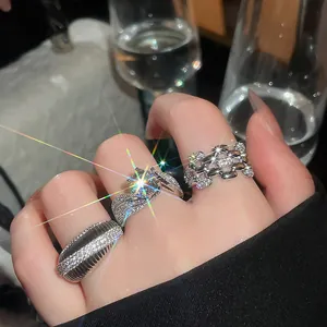 Close-up of sparkling 14k gold-plated zircon rings with elegant geometric designs.