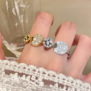 Close-up of elegant gold and silver rings featuring zircon-encrusted star motifs.