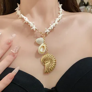 Macro view of a beach-style necklace featuring starfish beads and golden shell pendants.