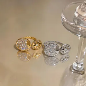 Close-up of gold and silver zircon rings featuring star and moon motifs