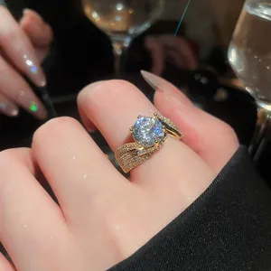 Close-up of a sparkling 14k gold plated zircon ring on finger in a luxury setting