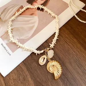 Detail shot of starfish bead necklace with golden shell pendant for beach vacations.