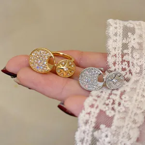 Close-up detail of elegant gold and silver rings featuring eight-pointed star and moon zircon