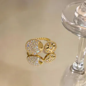 Close-up of a gold-plated eight-pointed star and moon ring with sparkling zircon stones