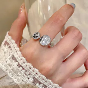 Close-up detail of silver open ring with zircon and eight-pointed star motif.