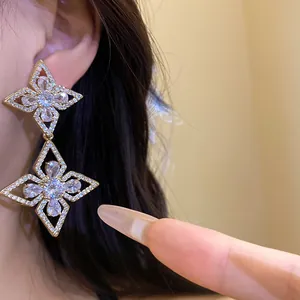 Detailed close-up of luxurious zircon flower drop earrings with sparkling water-drop stones