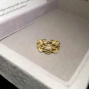 Close-up of a 14k gold plated open ring with sparkling zircons in a jewelry box