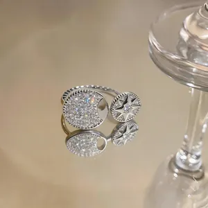 Detailed macro shot of an elegant eight-pointed star and zircon pavé open ring design.