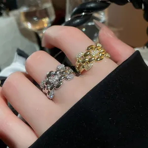 Close-up of elegant gold and silver zircon rings on fingers with sparkling details