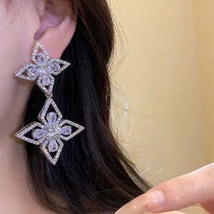 High-quality close-up of exquisite sparkling zircon flower pendant earrings for women