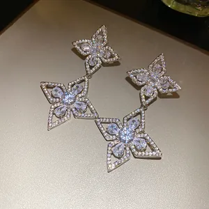 Exquisite detail of silver color earrings featuring shimmering white zircon flower charms