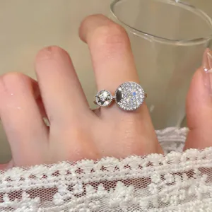 Elegant silver ring featuring pave-set zircon circles and a star design on a finger