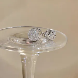 Detailed macro view of silver ring with eight-pointed star and sparkling zircon