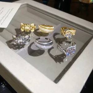 Detailed view of six adjustable zircon plated rings in gold and silver luxury designs
