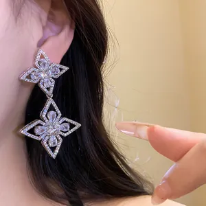 Detailed macro view of silver zircon flower drop earrings with sparkling rhinestone stones