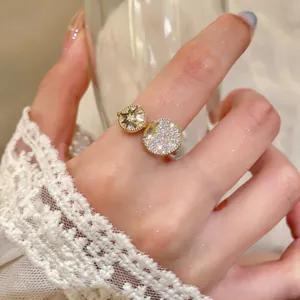Detailed macro shot of an elegant gold octagram zircon open ring on a woman's finger