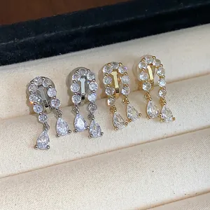 Detailed view of 18k gold plated waterdrop clip-on earrings with pavé zirconia crystals