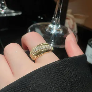 Close-up detail of a 14k gold plated ribbed band ring featuring pavé-set cubic zirconia stones