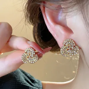 Elegant 14k gold-plated knot stud earrings featuring brilliant baguette zircon stones