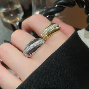 Close-up of 14k gold plated geometric rings with inlaid zircons and ribbed texture