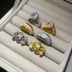 Detailed view of sparkling 14k gold plated zircon rings arranged in a velvet jewelry box